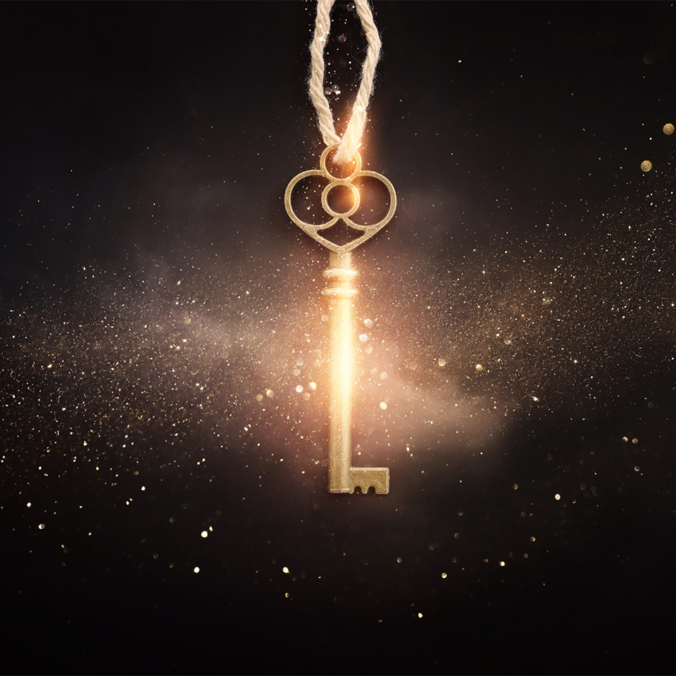 Golden key with glowing lights and dark background
