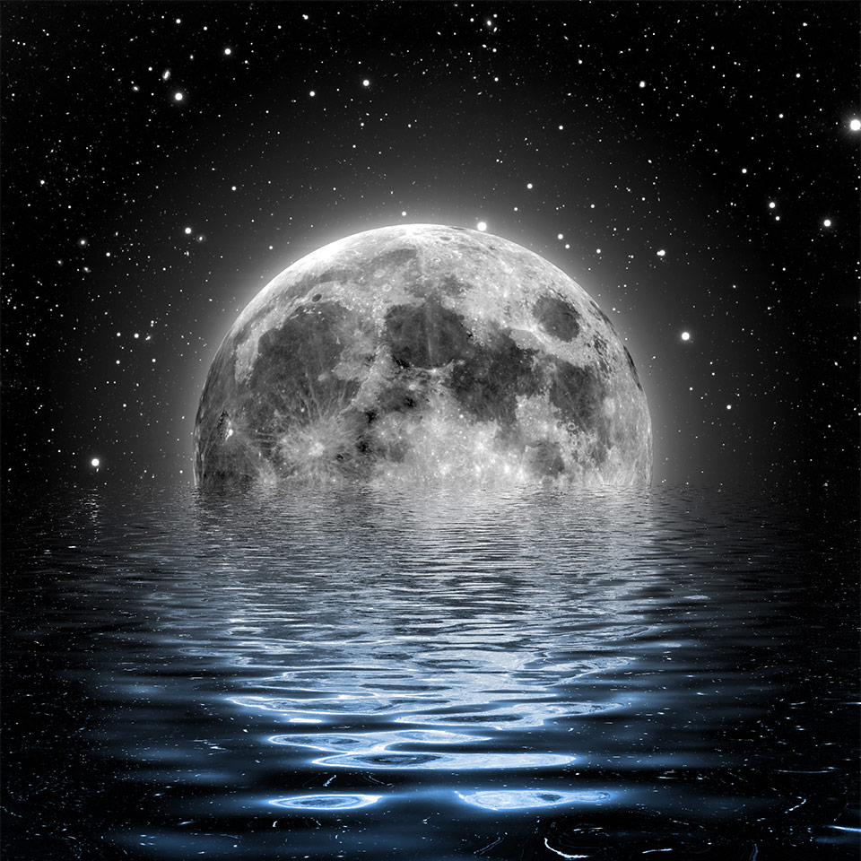 A large moon, partially submerged in the sea