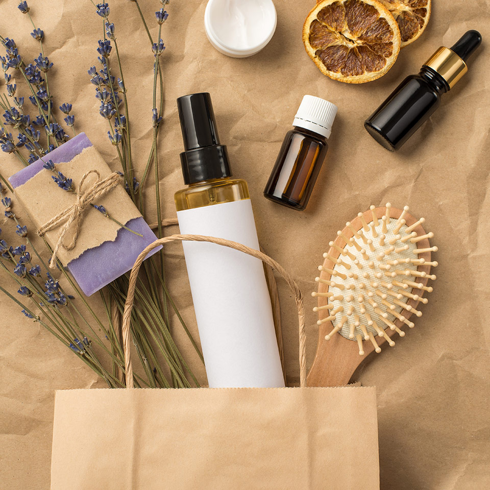 Top view photo of organic haircare products and springs of lavender in a paper bag