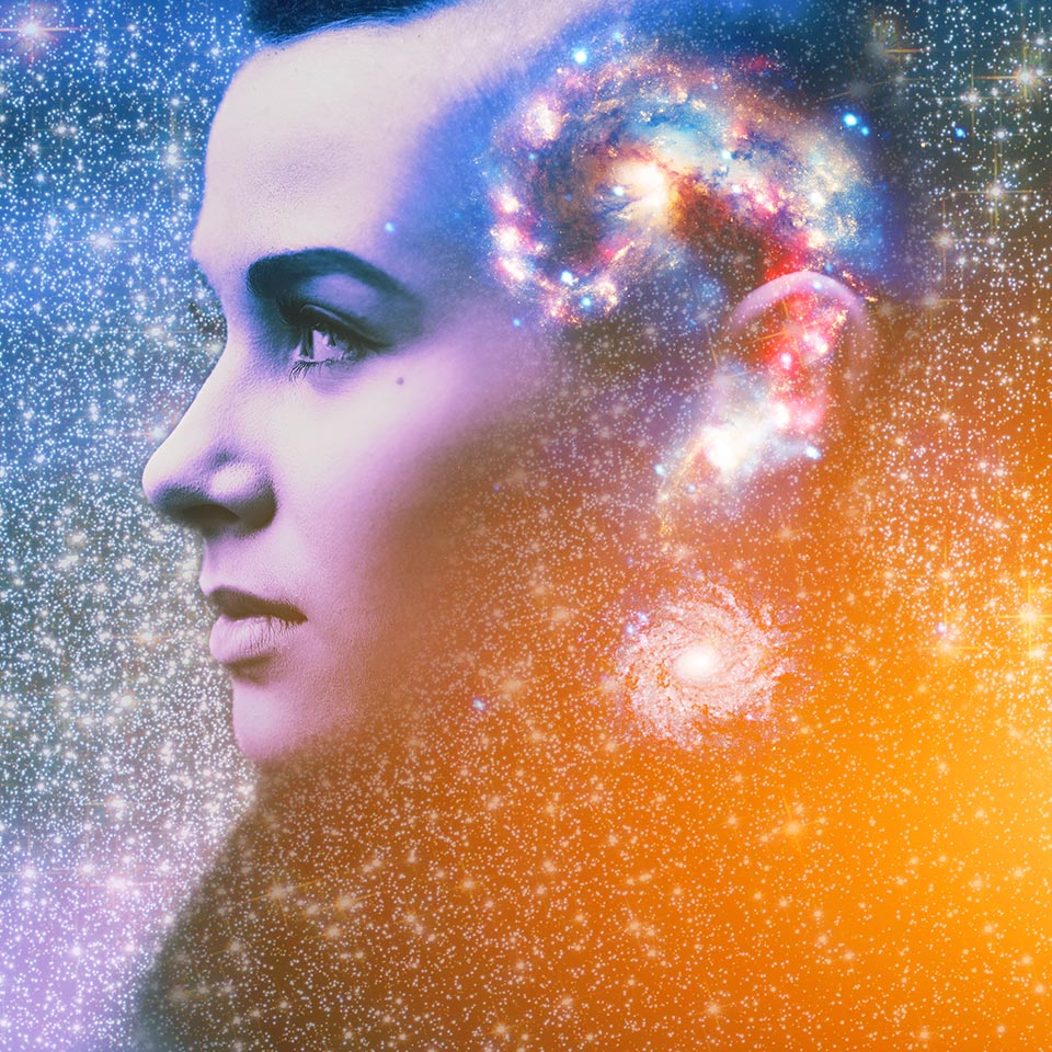 Double multiply exposure abstract portrait of young woman's face with a galaxy in the shape of a question mark inside her head