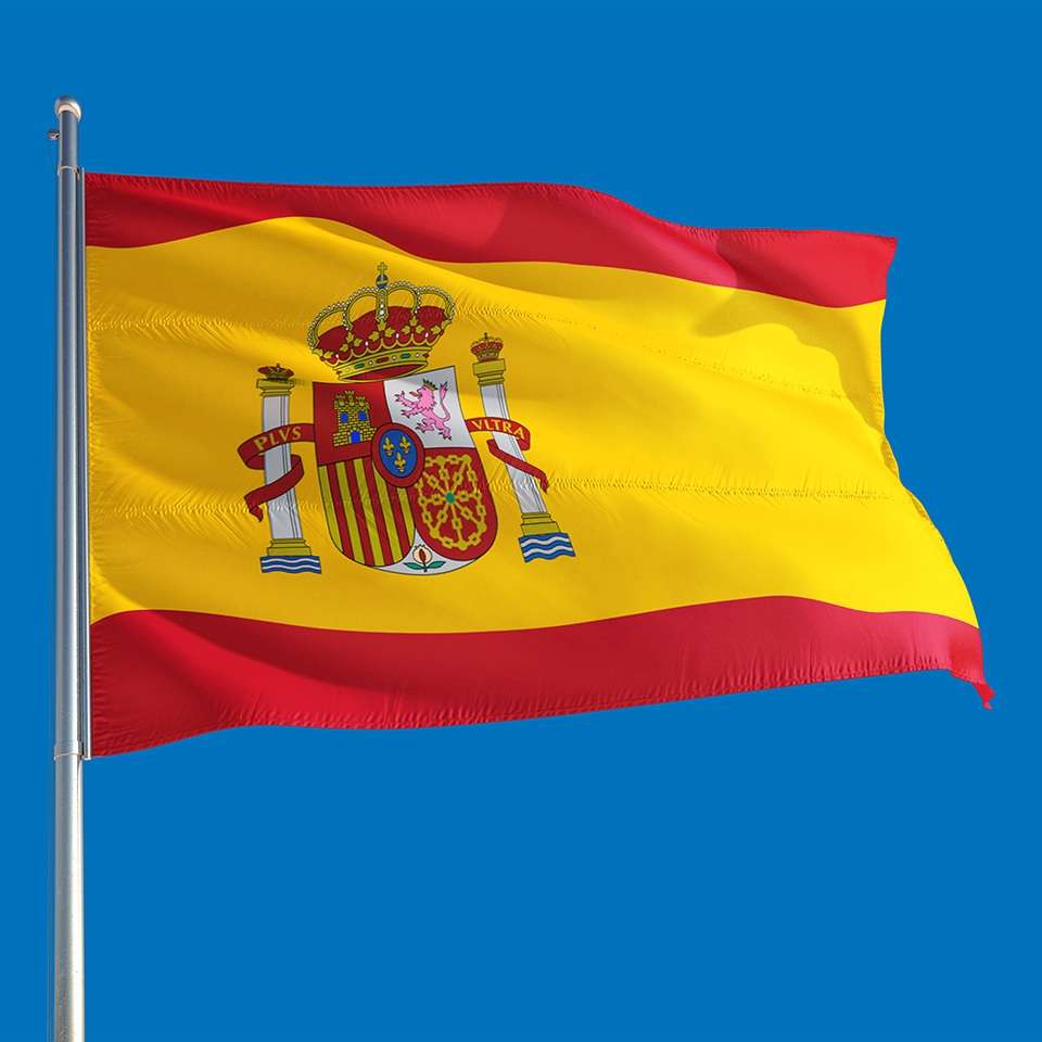 Spanish flag waving in the wind on a deep blue sky